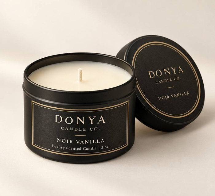 DONYA Noir Vanilla soy candle in a black 3 oz travel tin